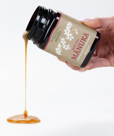 Pouring Manuka honey out of jar